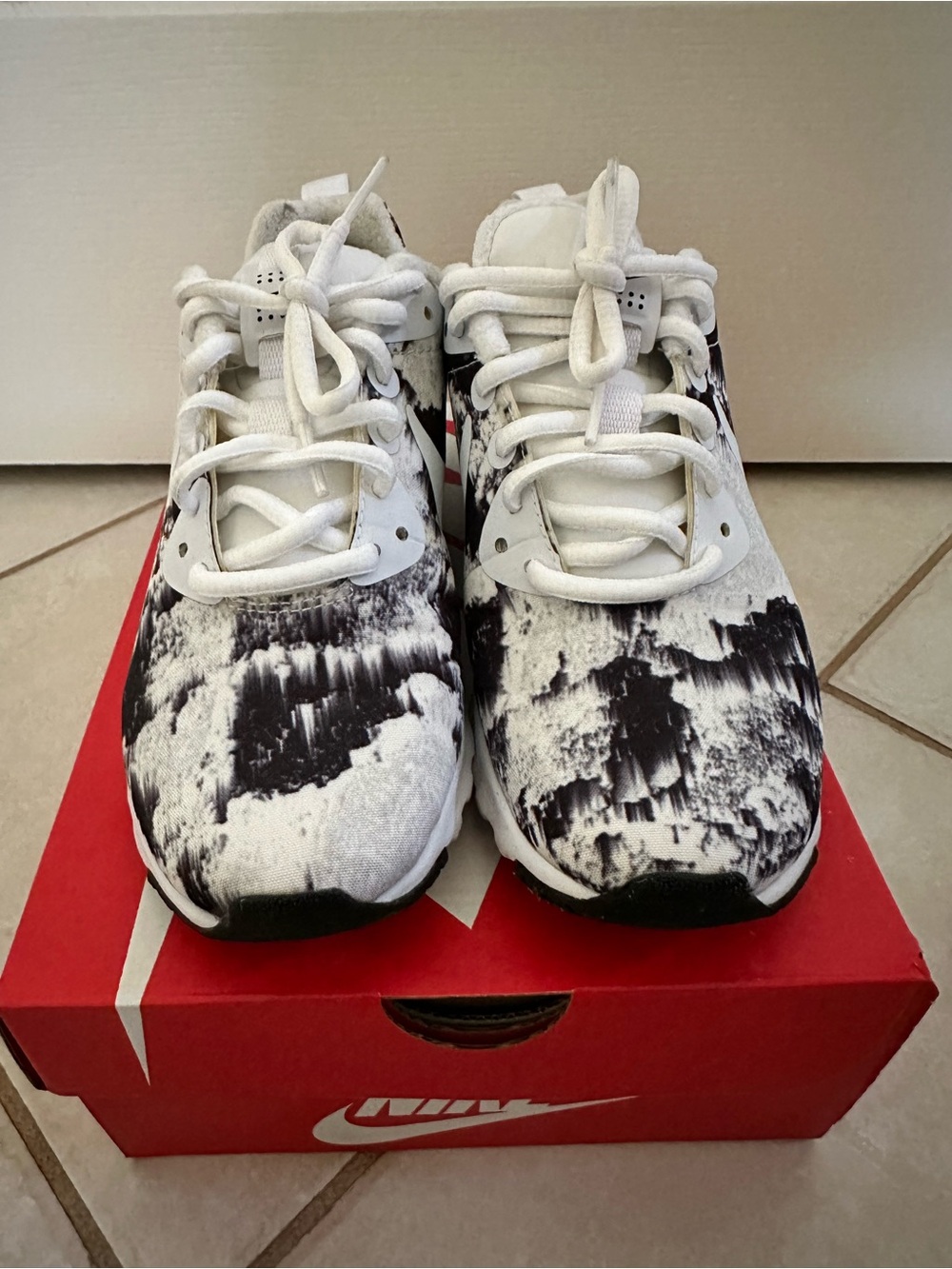 Women’s Black & White Patterned Athletic Nike Air sneakers.